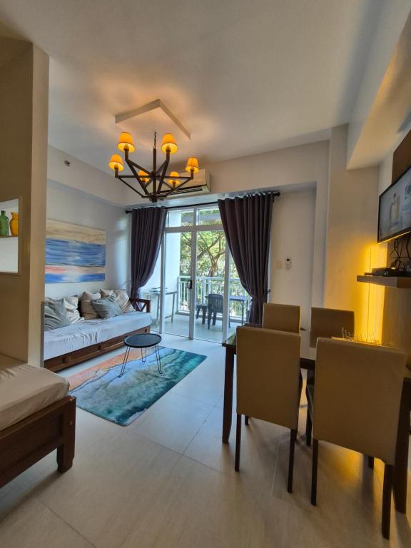 a living room with a dining table and a couch at Tropical Escape at Pico De Loro in Nasugbu