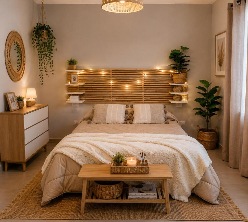 a bedroom with a large bed with lights on it at Maison La Reggia in Caserta