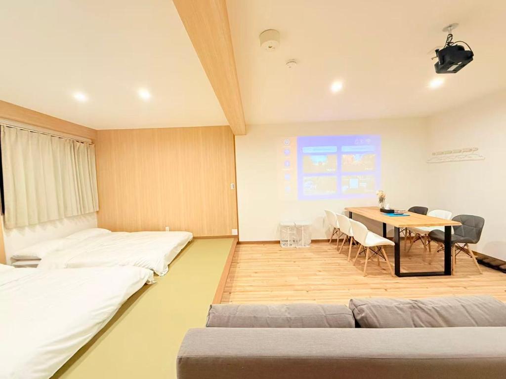 a room with beds and a table with chairs at クリスタルSky tree Hotel in Tokyo