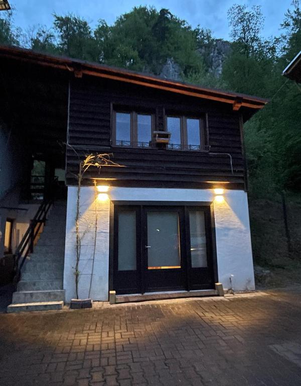 a house with lights on the front of it at Ostoja in Ojców