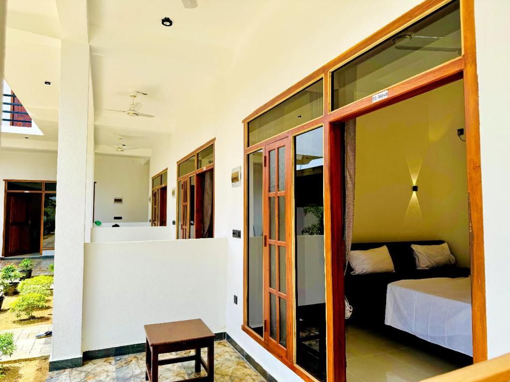 a bedroom with a bed and a small table at Surf del mar in Arugam Bay