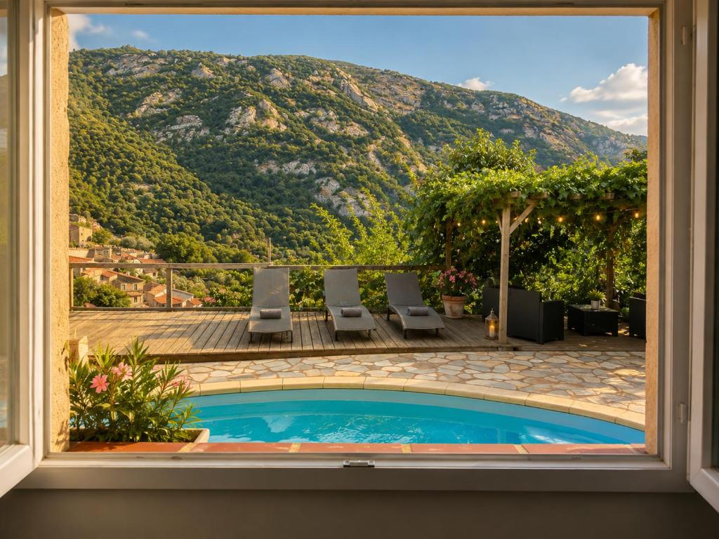 a view from a window of a swimming pool with a mountain at Casa Versini in Balogna