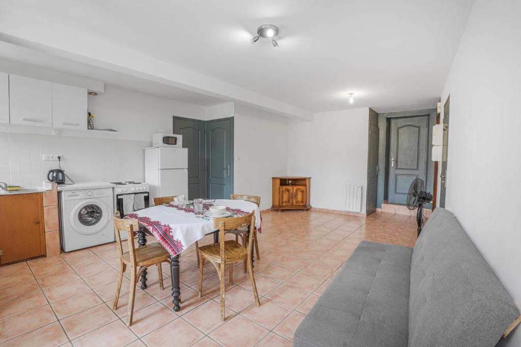 a kitchen and dining room with a table and chairs at Boni in Saint-Julien-Molin-Molette