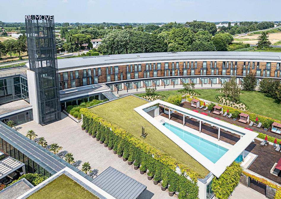 an aerial view of a building with a swimming pool at MOVE Hotels Venezia Nord in Mogliano Veneto