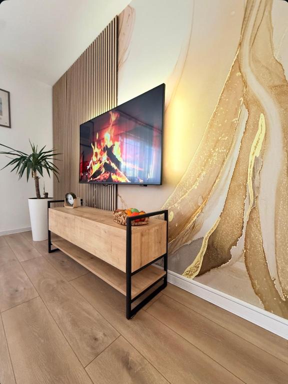 a living room with a flat screen tv on a wall at Apartment Mey in Sarajevo