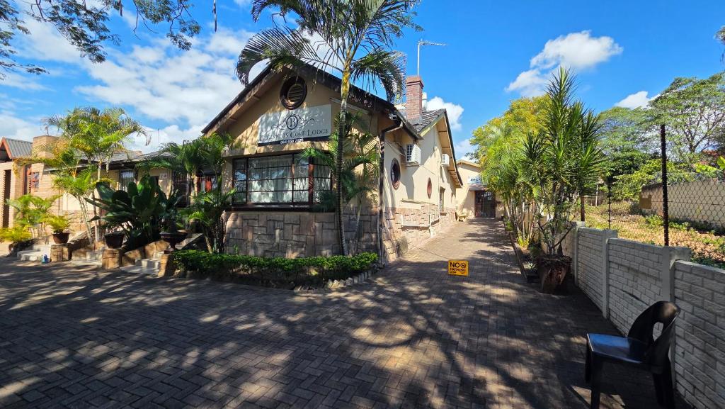 a house on a street with a fence at Beginners Cove Lodge in Nelspruit