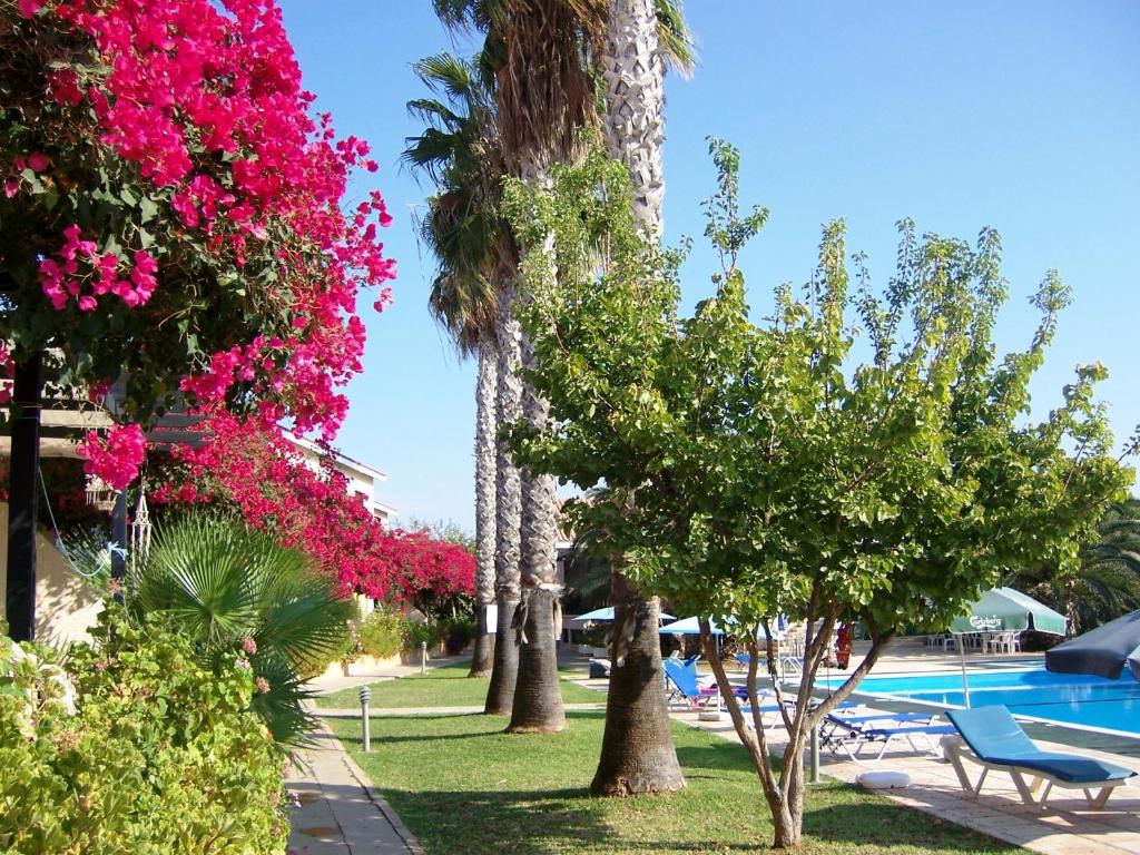 a resort with palm trees and a swimming pool at Mon Repos Hotel in Ayia Napa