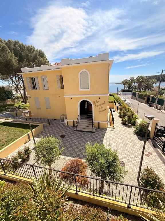 a yellow house with a walkway in front of it at Caravelle 60 in Antibes