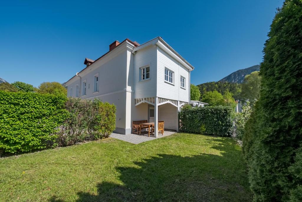 a large white house with a yard at Alte Schule Reichenau an der Rax in Reichenau