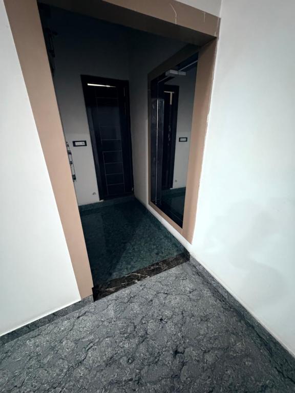 an empty corridor in a building with a mirror at NaPrer Homes in Dehradun