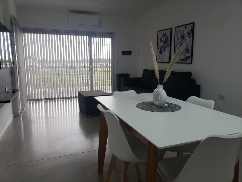 a living room with a white table and chairs at Departamentos Felice in Santa Rosa