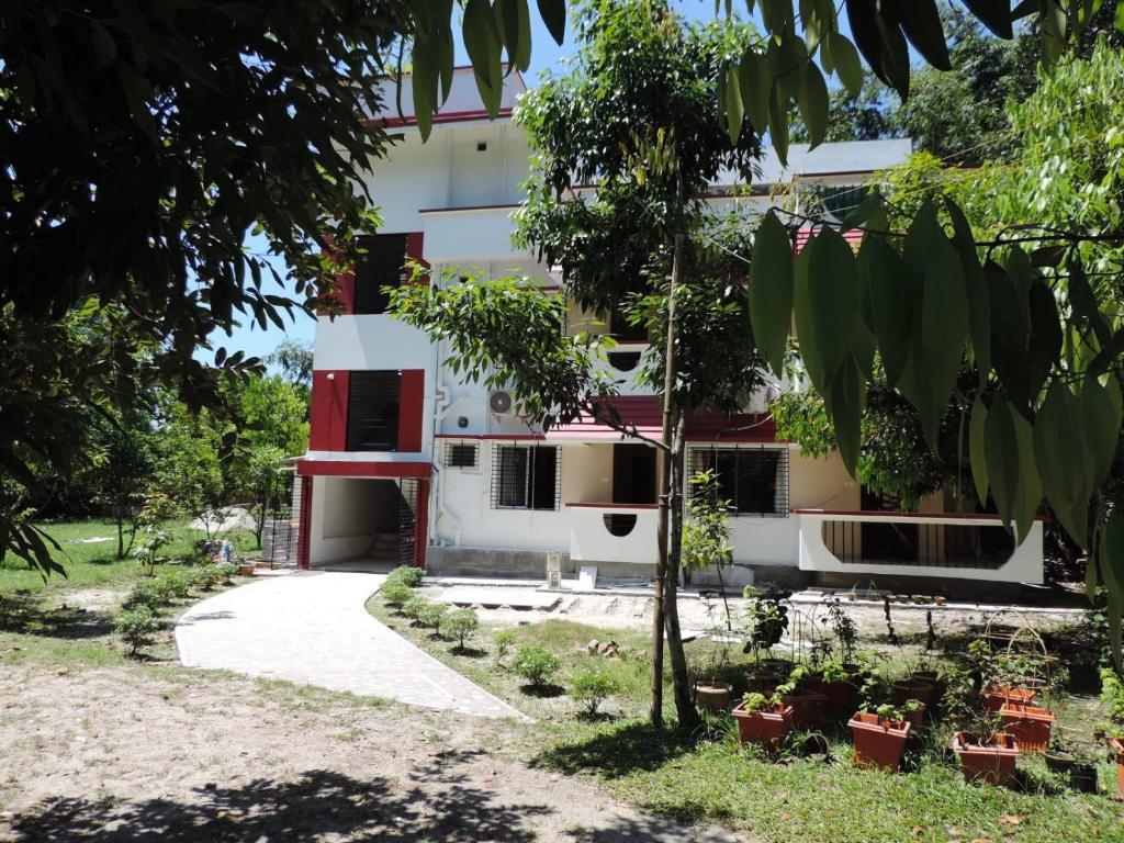 a building with trees in front of it at Boroli in Shaugaon