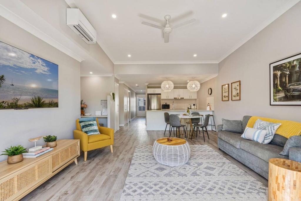 a living room with a couch and a table at Family-friendly Seaside Gem in Urangan
