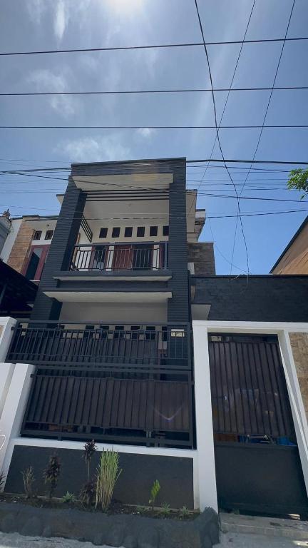 a black and white house with a balcony at waterspring home in Banyuwangi