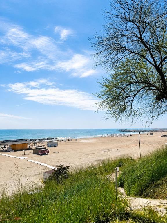 a beach with a lot of people and the ocean at Casa Scriitorilor in Olimp