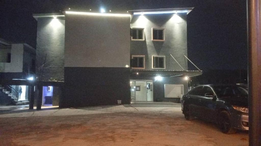 a car parked in front of a building at night at Edo Global Hotel & Suites in Benin City