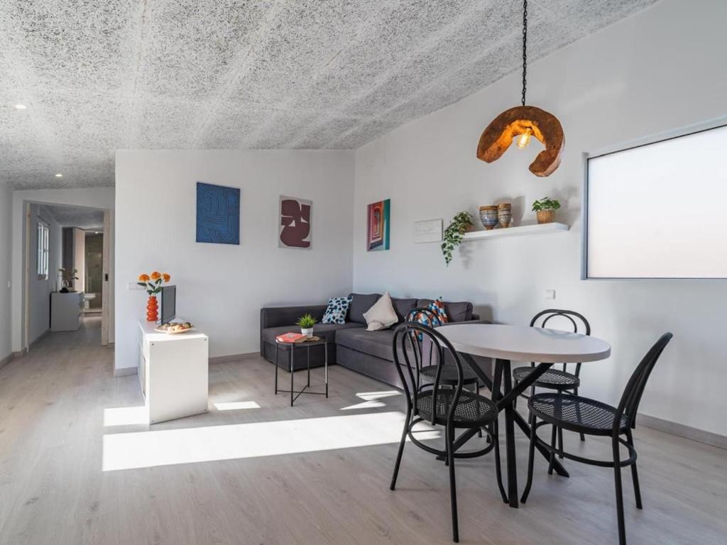a living room with a table and a couch at Winahost Pla de Can Sans in Sant Andreu de Llavaneres