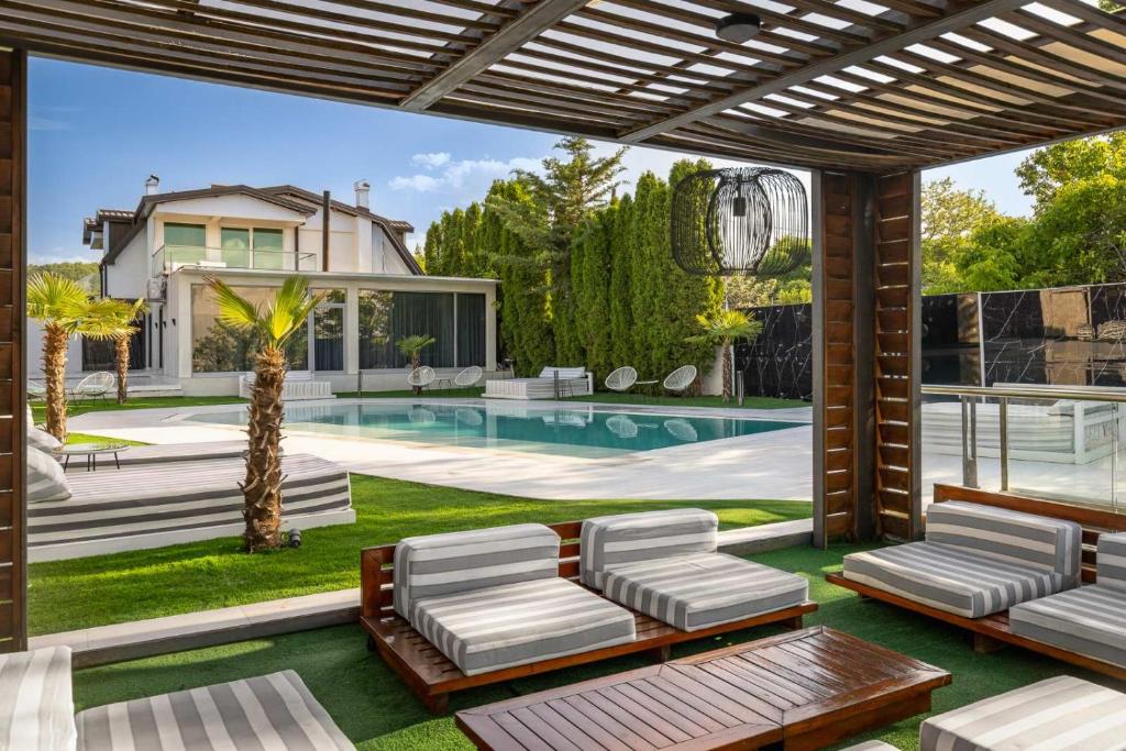 a backyard with a swimming pool and a house at Aura Villas Skopje in Skopje