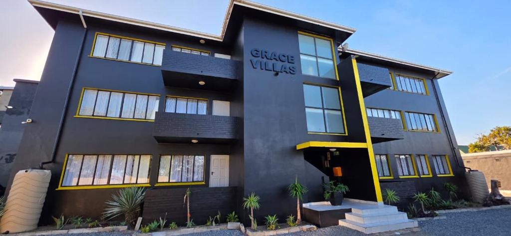 a black building with a sign on it at Grace Villas 1 in East London