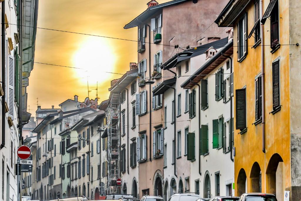 a city street with buildings and cars on the street at Belle Arti in Bergamo