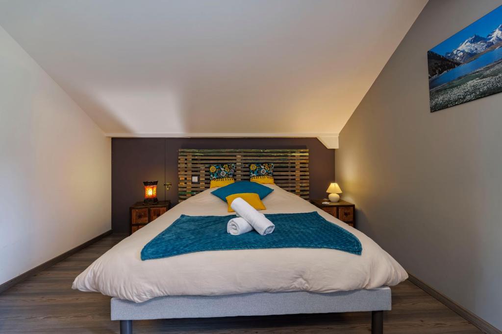 a bedroom with a bed with a towel on it at Au doux passage in Les Rousses