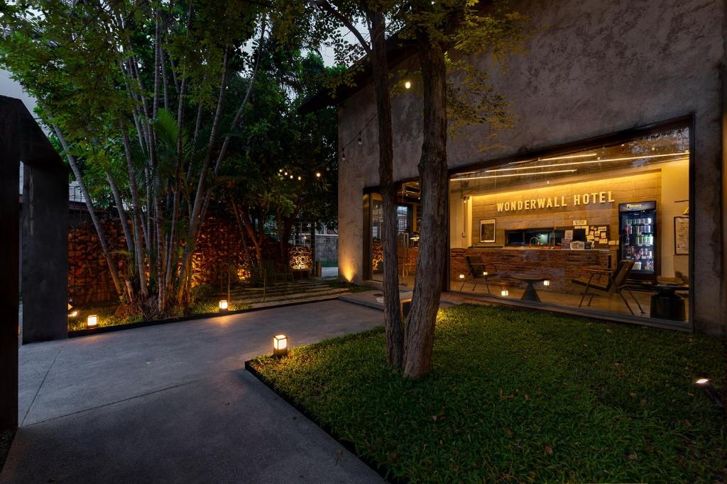 a store front of a building at night with lights at Wonderwall Hotel in Chiang Mai