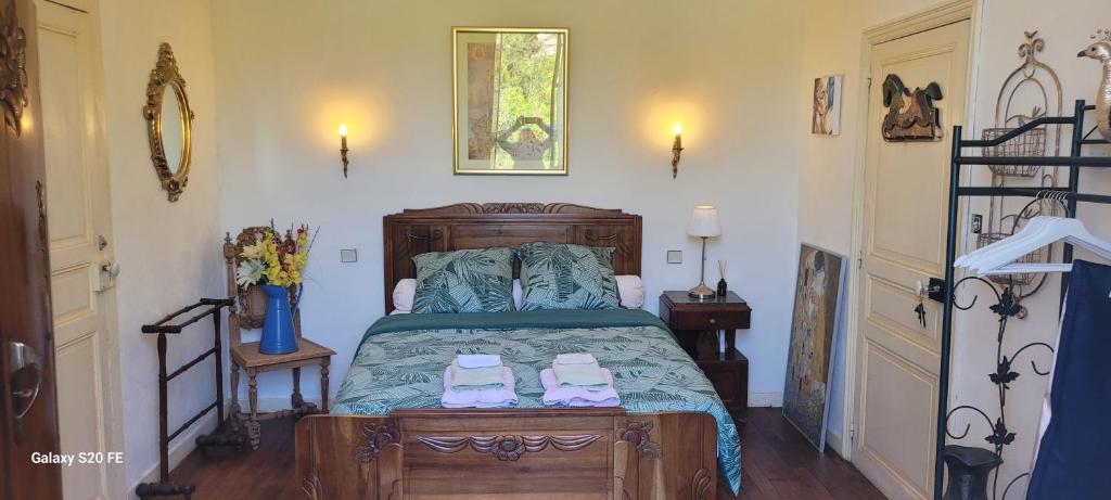 a bedroom with a bed with two shoes on it at La Chambre d'Artiste in Laguépie