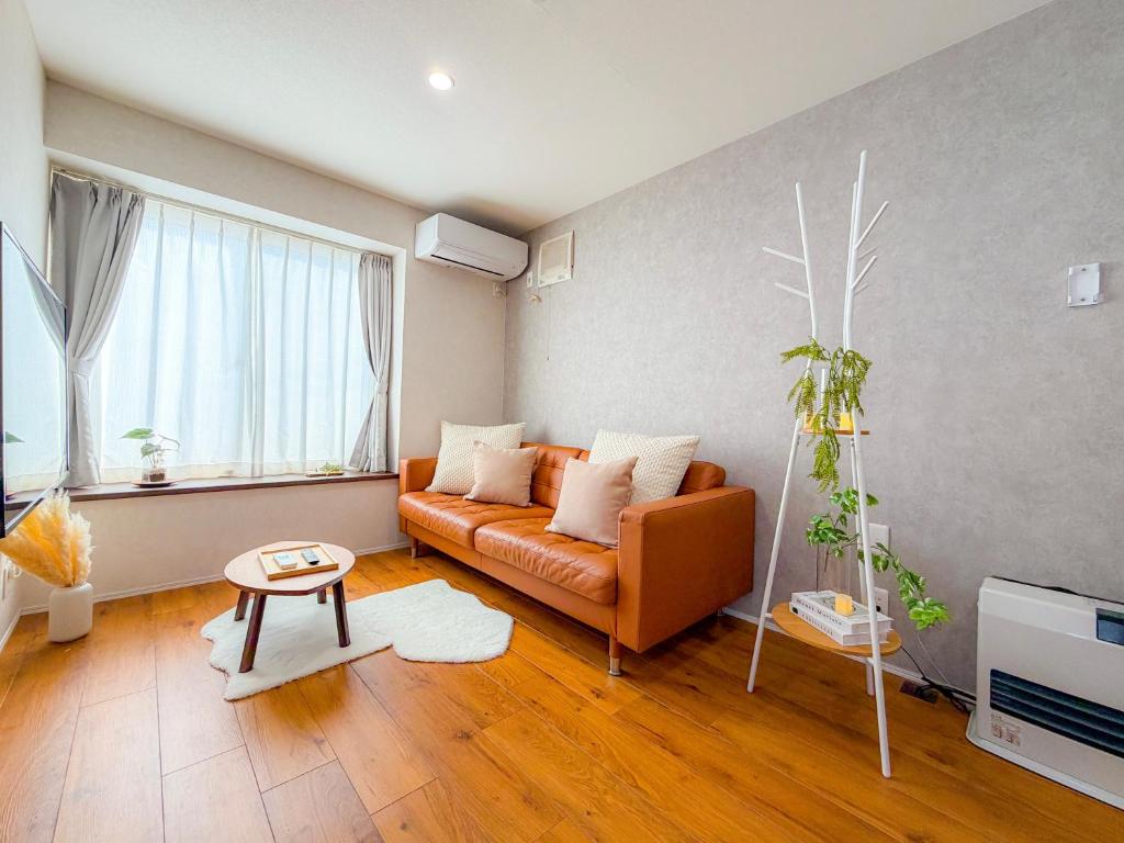 a living room with a couch and a table at Shirakaba in Otaru