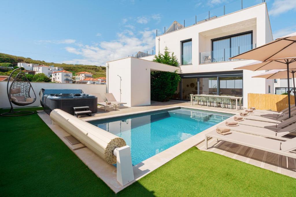 a villa with a swimming pool and a house at Paradise Villa Sky - Signature by Paradise Portugal in Ribamar