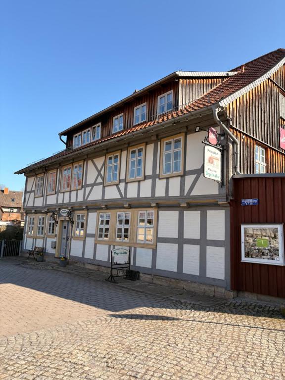 a building with a white and brown building at BohnApartments Vogelmühle Ilsenburg in Ilsenburg
