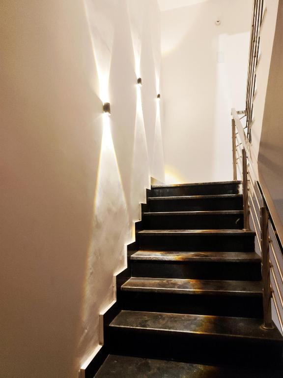a stairway with a bunch of lights on the wall at Hotel Kashi Bliss in Varanasi
