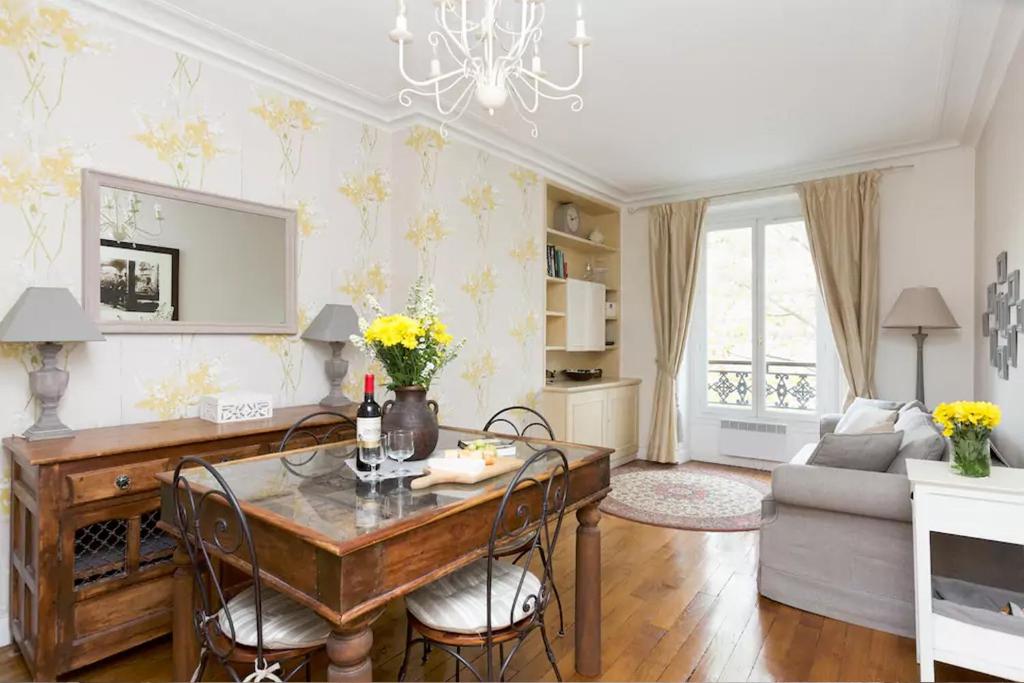 a living room with a table and a couch at Apartment Ternes in Paris