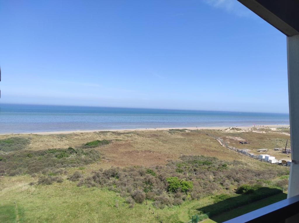 a view of the beach from a window at Westdiep 602 zeezicht, verwarmd binnenzwembad in De Panne