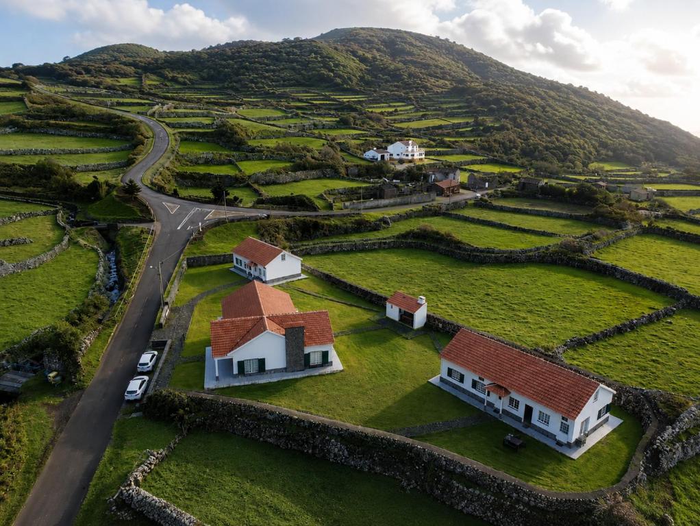 an aerial view of a village with houses and a road at Casas da Cascata in Lajes das Flores