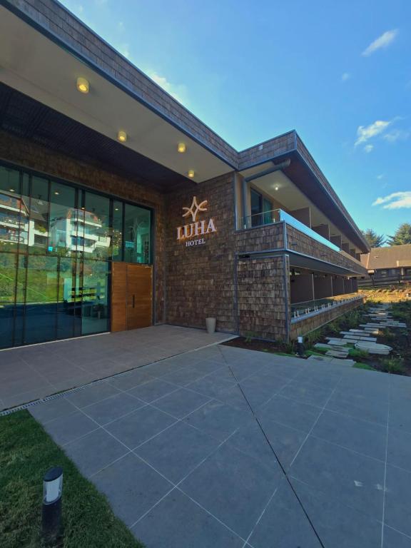 a building with a sign that reads lula at Hotel LUHA in Puerto Varas