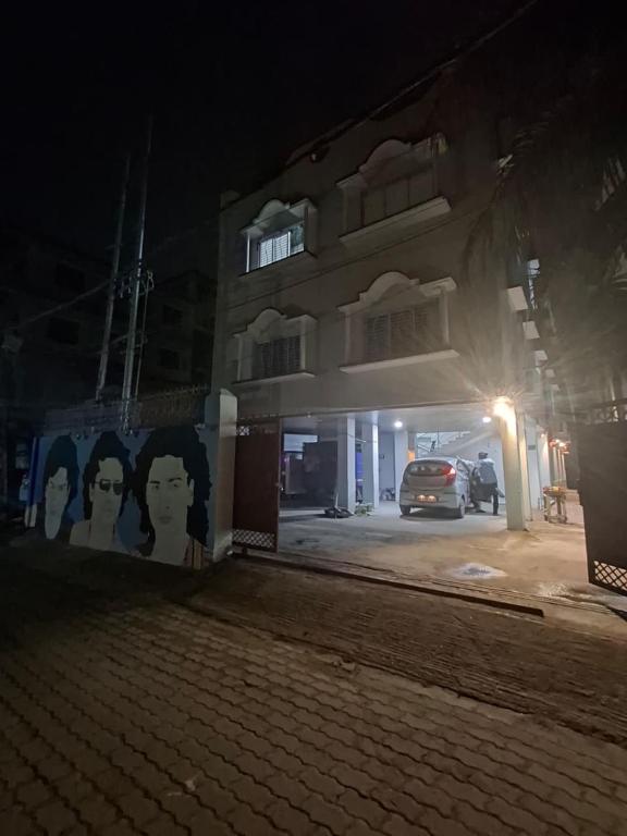 a car parked in front of a building at night at Nahor Residency in Guwahati