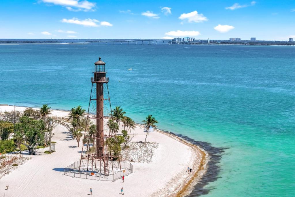 a lighthouse on a beach next to the ocean at Lighthouse Point A311 in Sanibel