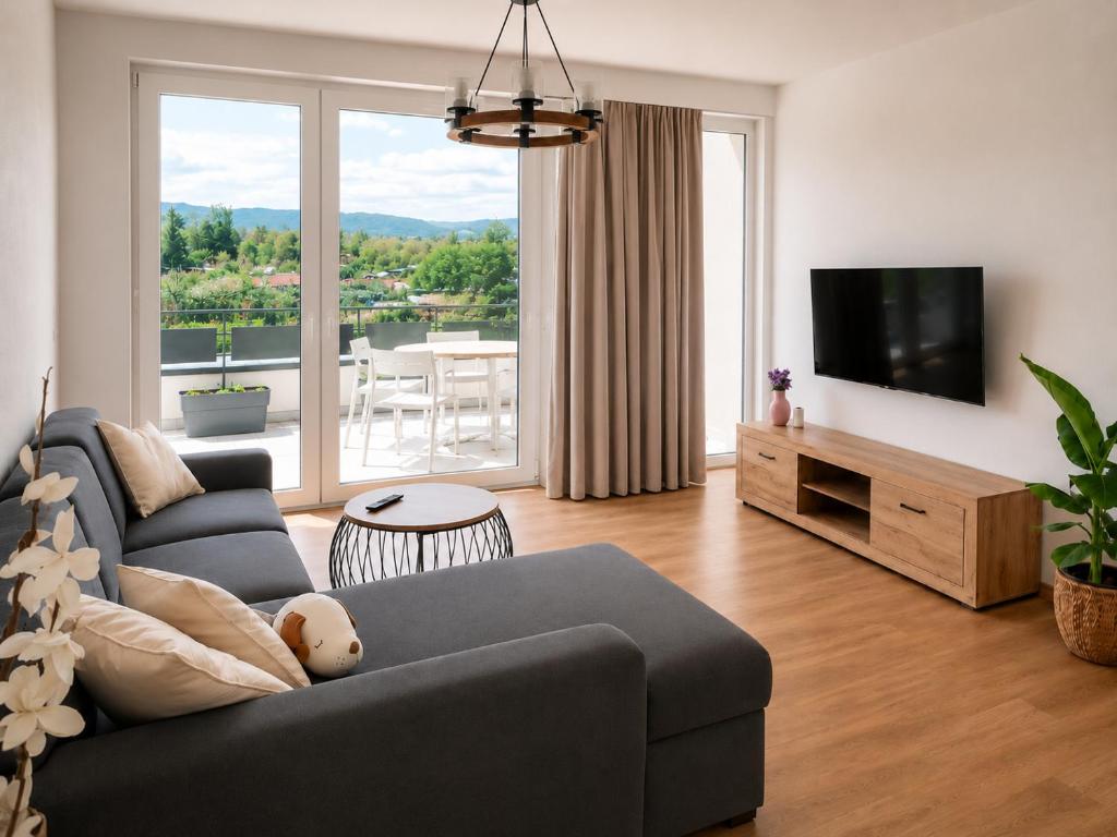 a living room with a couch and a flat screen tv at Apartmán Viktória in Poprad