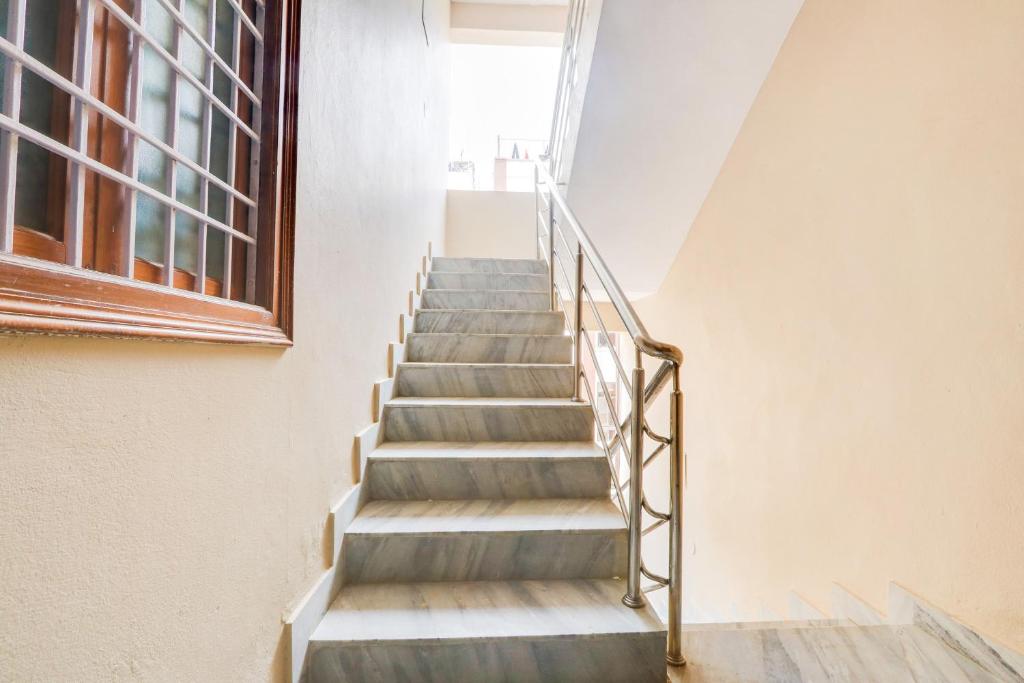 a staircase in a building with a window at Hotel O Castle Inn Kondapur in Hyderabad