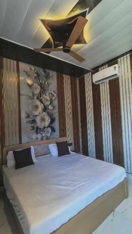 a bedroom with a bed with a ceiling fan at Tranquil Nature Resort in Rāipur