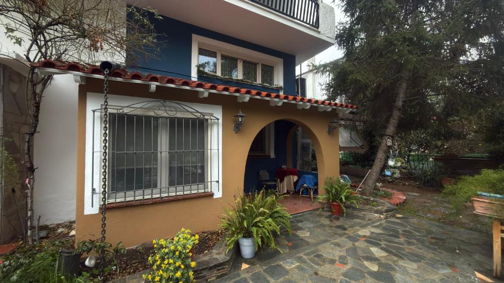 a blue and yellow house with a patio at Sweet Studios Kavala in Kavála
