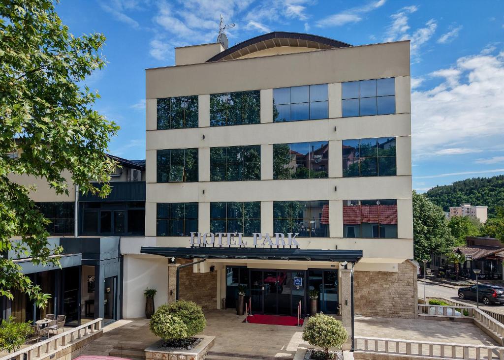 a building with a sign on the front of it at Hotel Park in Široki Brijeg