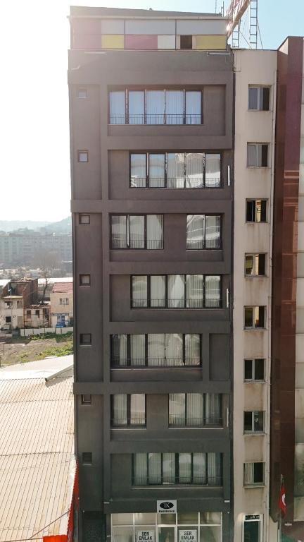 a tall apartment building with a crane on top of it at Tk Residence in İzmir