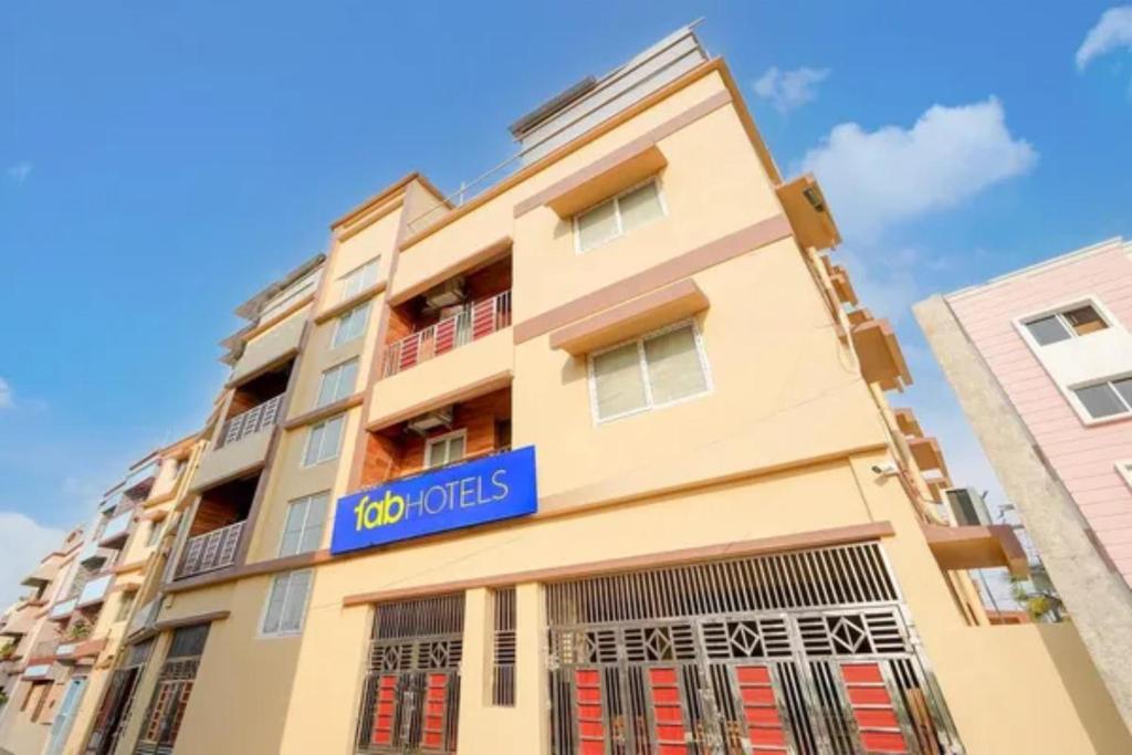 a building with a blue sign on it at Fabhotel Grant Heights - Nr Biju Patnaik International Airport in Bhubaneshwar