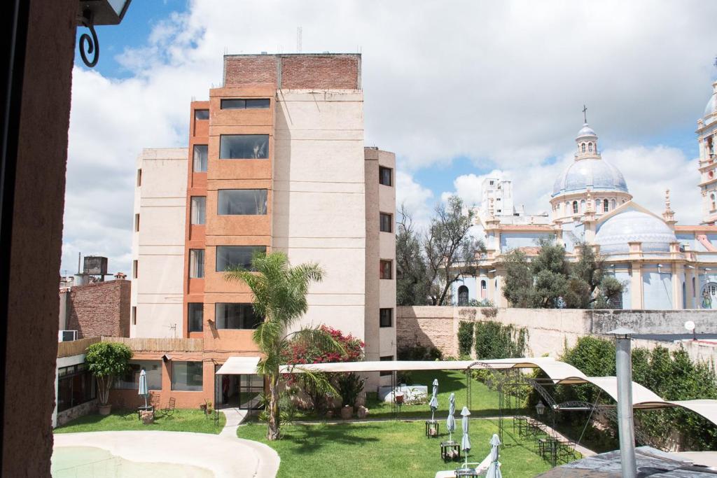 a view of a building with a green yard at Hotel Samka in Salta