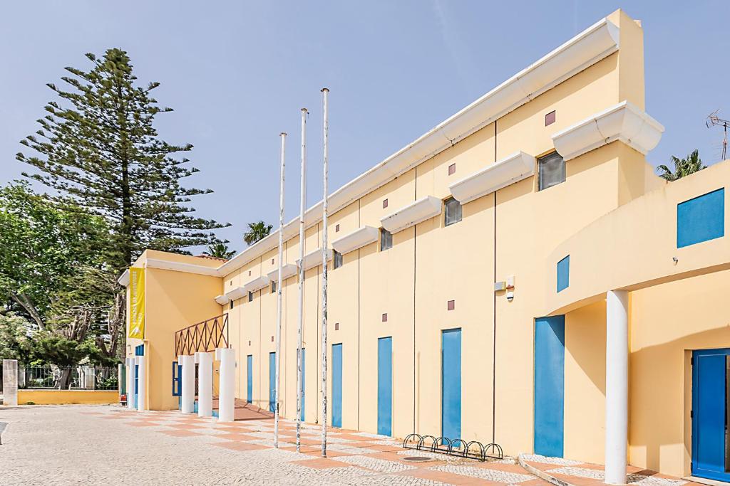 a building with blue windows and scaffolding at HI Faro – Pousada de Juventude in Faro