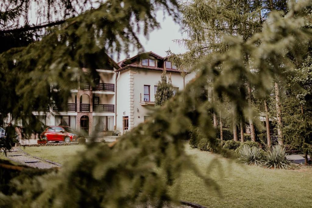 a house with a red car parked in front of it at Zacisze Zbiczno in Zbiczno