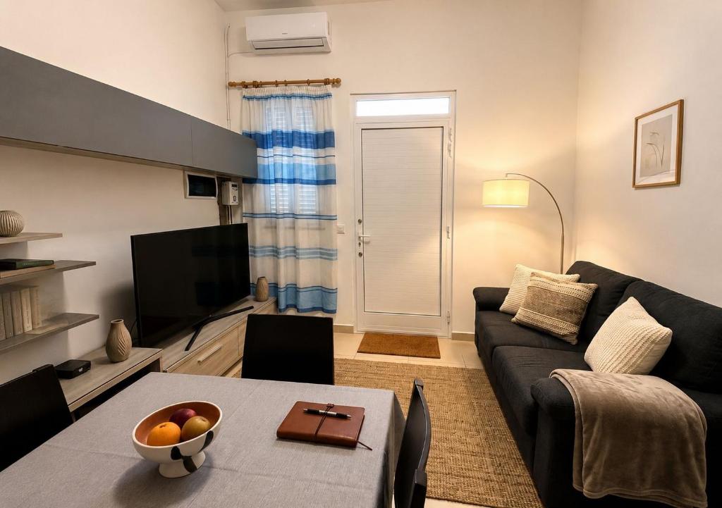 a living room with a couch and a table at Tac-Coghki Maisonette in Rabat