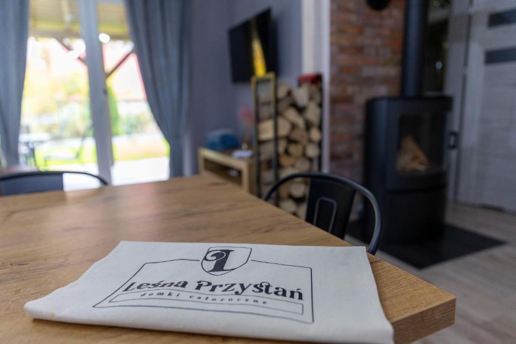 a napkin sitting on top of a wooden table at Leśna Przystań in Sasino