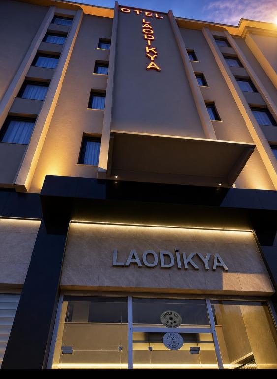 a building with a sign on the side of it at Laodikya Hotel in Denizli